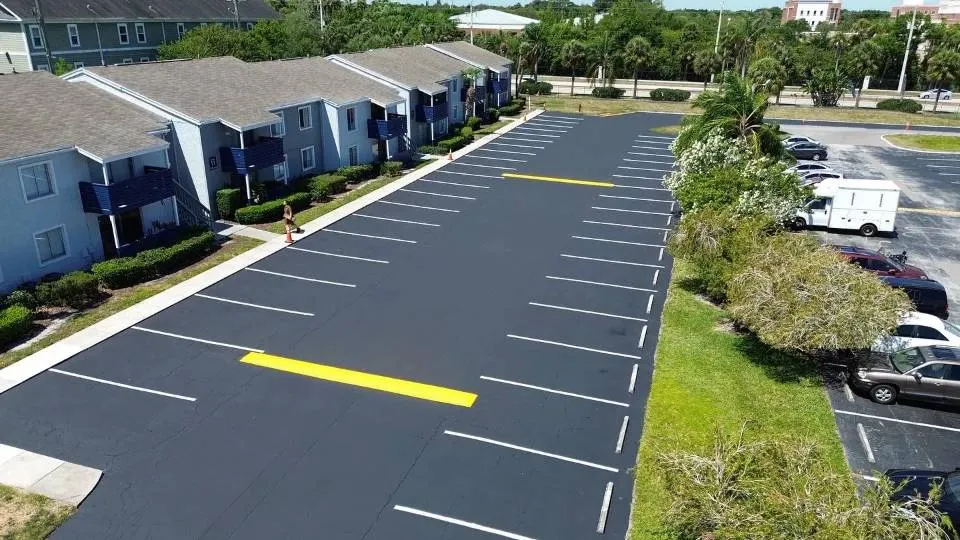 Aerial view of a freshly paved and striped parking lot by All Brevard Asphalt