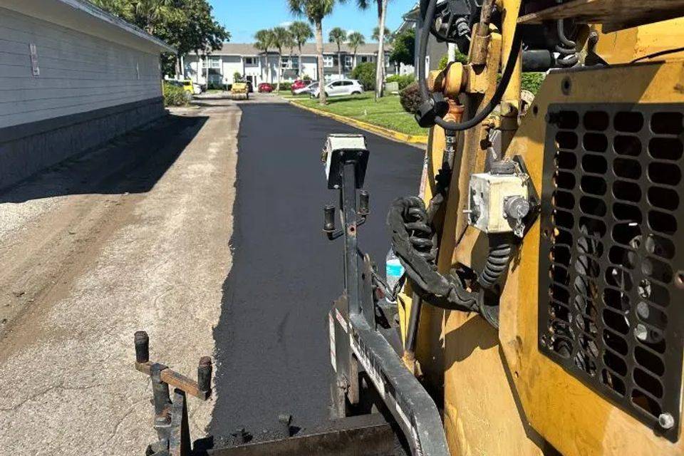 Compact loader preparing a site before paving
